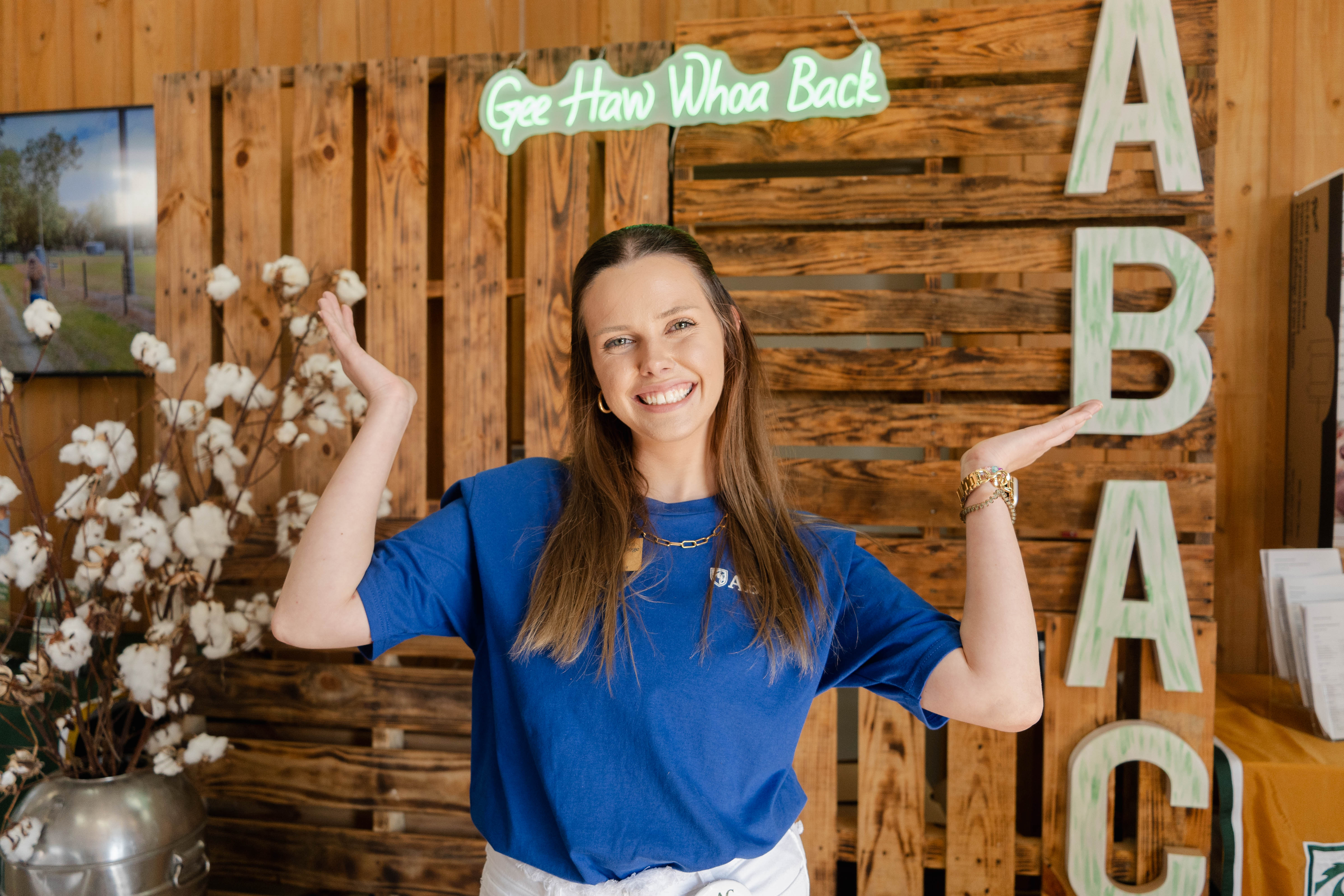 female student with gee haw sign