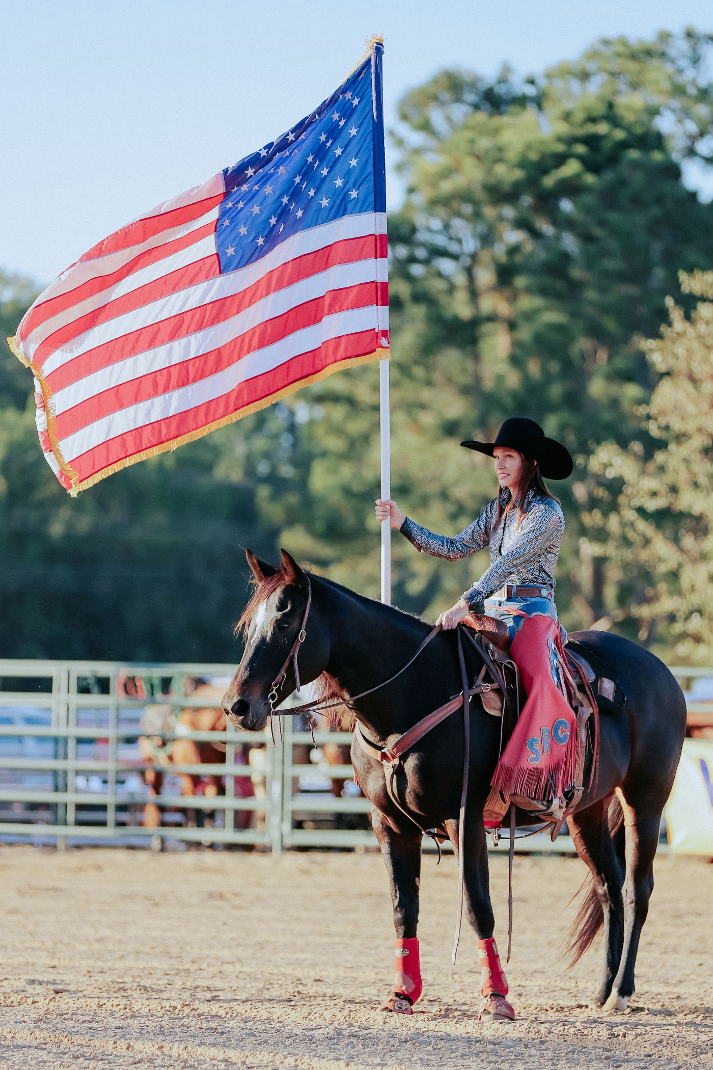girl on a horse holding a flag