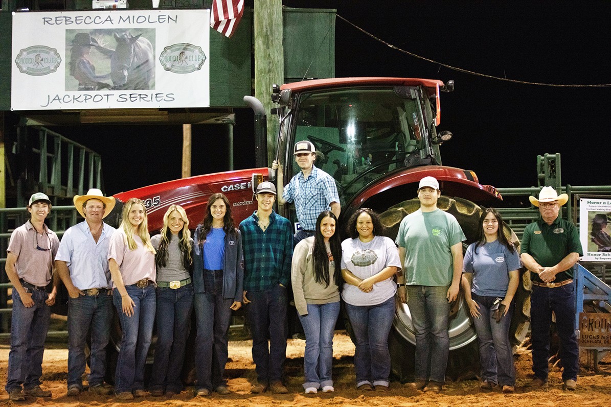 rodeo club in front of tractor