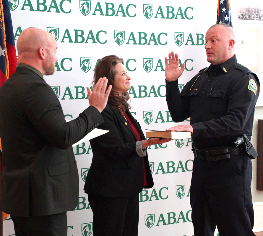 three people during a swearing-in