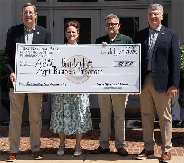 people holding a large check