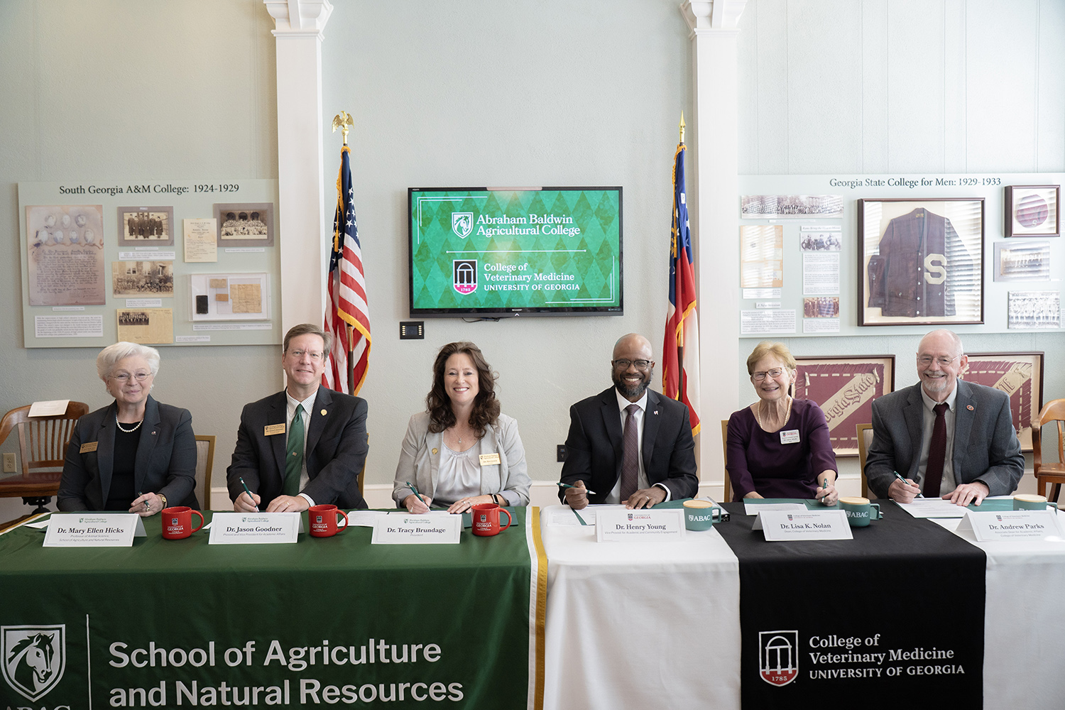 college officials signing an agreement