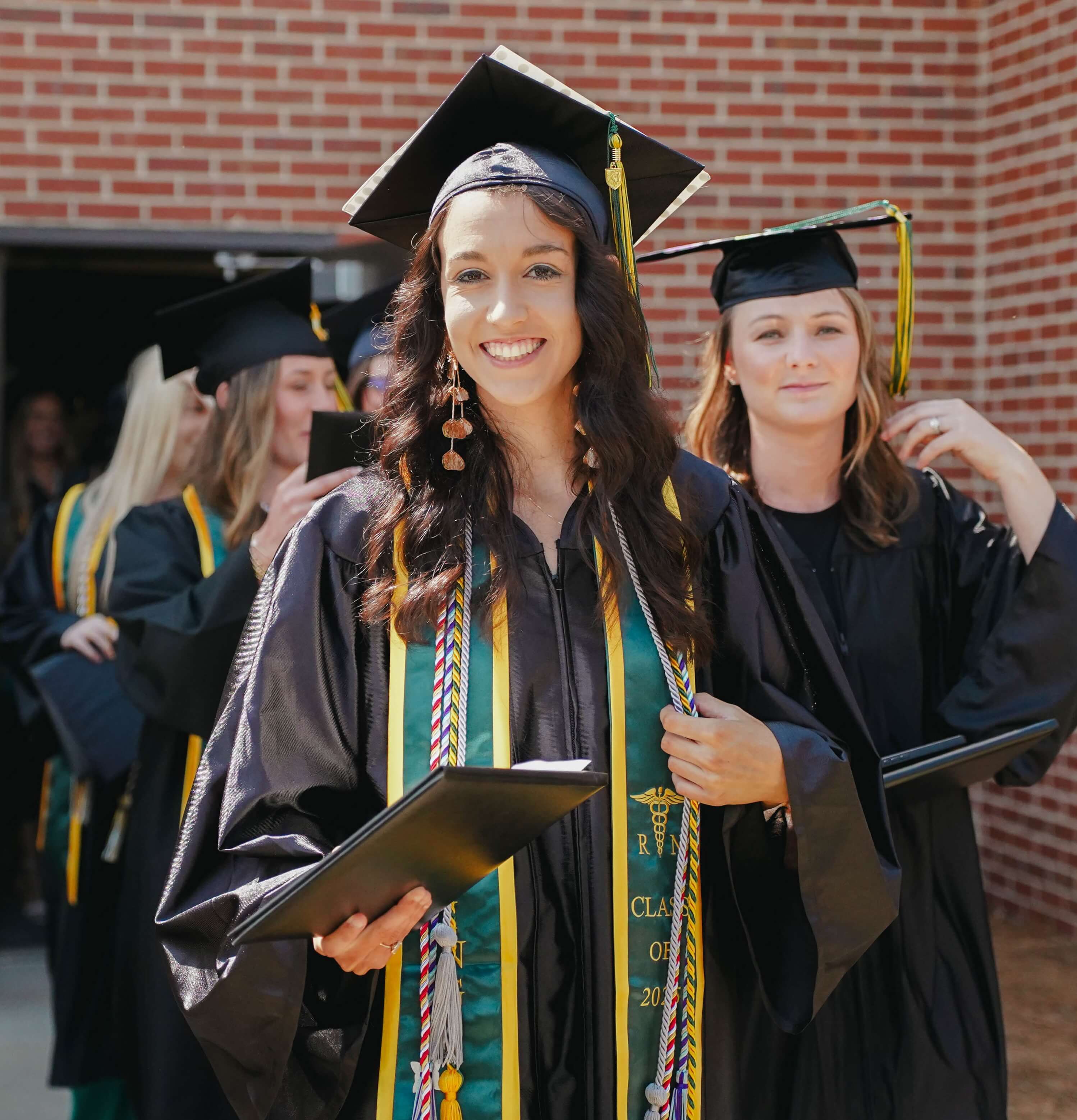 students in regalia at graduation