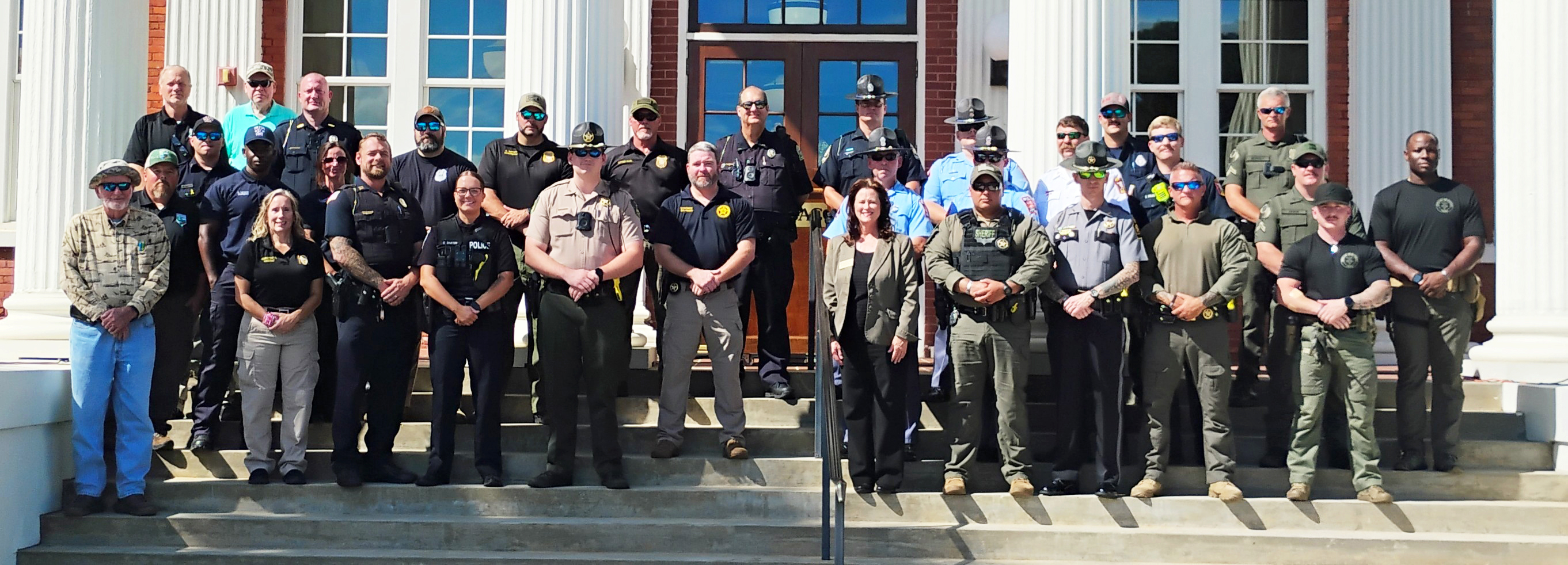 first responders and president brundage pose in front of tift hall